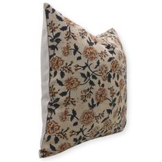 a decorative pillow with an orange and black flower pattern on the front, sitting on a white background