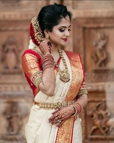 a woman wearing a white and red sari