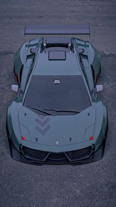 the rear end of a sports car parked in a parking lot with no one around