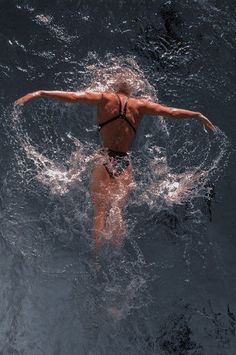 a woman is swimming in the water