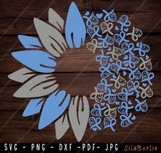 the blue and white flower is cut out from wood, with an intricate design on it