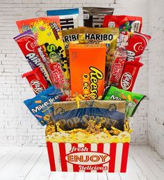 This candy bouquet is designed to look like a popcorn bucket, making it a fun and festive centerpiece for your movie night. It's also a fantastic gift for movie lovers, birthdays, or any occasion that calls for a sweet celebration. | Transform any movie night into an unforgettable experience with our Movie Night Candy Bouquet! Perfect for family gatherings, date nights, or a solo film fest, this candy bouquet is brimming with all the sweet and savory treats you love from the theater. Each bouquet is thoughtfully arranged to capture the magic of a classic movie night. | 1-800-Flowers Everyday Gift Delivery Movie Night Candy Bouquet Movie Night Candy, Movie Theater Candy, Candy Bar Bouquet, Candy Bar Cake, Bucket Gifts, Fathers Day Gift Basket, Candy Arrangements, Valentine's Day Gift Baskets, Food Gift Baskets