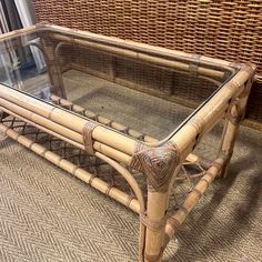 a glass top coffee table made out of bamboo