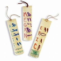 three wooden bookmarks with writing on them