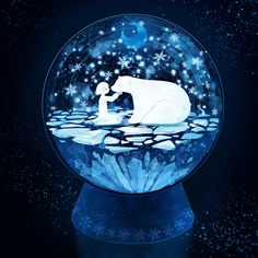 a snow globe with an image of a polar bear and its cub in the water