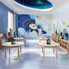 the children's room is decorated in blue and white with an artistic mural on the wall