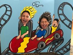 two children are riding on a roller coaster