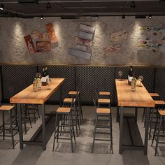 an empty restaurant with wooden tables and stools in front of a wall decorated with pictures