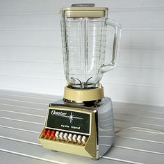 a blender sitting on top of a counter next to a white wall and floor