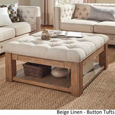 a living room with couches, tables and pillows on the carpeted flooring