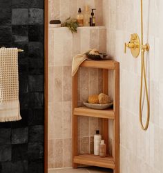 there is a shelf in the bathroom with towels on it and soaps next to it