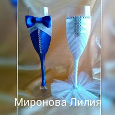 two wine glasses decorated with blue and white ribbons