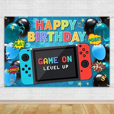 a birthday banner with video game controllers and balloons