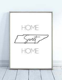 a white framed poster with the words home sweet home in black and white on it