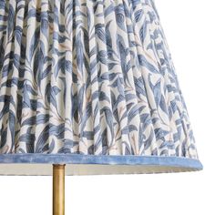 a blue and white lampshade with a gold base