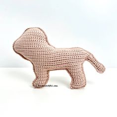 a crocheted dog is shown on a white surface