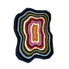 a multicolored rug with an oval design on the center and bottom, against a white background