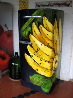 a refrigerator decorated with bananas and leaves