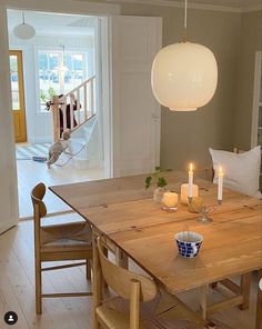 a dining room table with candles on it