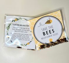 a package of bee seed packets sitting on top of a white table next to a yellow and black sticker