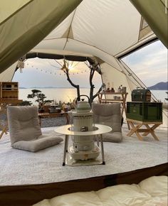 the inside of a tent with two chairs and a table