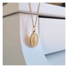 This beutiful oval shaped Miraculous Medal is made with 18 kt gold plating sterling silver. Medal is satin texture with diamond cut edges. Technique of making this medal is minting ( coining ) so it is very detailed. Item deatils:  Dimensions of medal is 25 mm or  (0'98 inch) x 11 mm(0,48 inch).  Weight of medal: 1, 8 gr. Available necklace lengths: 42 cm (16, 5 inch), 50 cm (19,7 inch) and 60 cm ( 23,6 inch). This size of medal is ideal for teenage girls or women that prefers miniature Miraculo Oval Miraculous Medal Jewelry For Commemoration, Spiritual Oval Jewelry For Commemoration, Oval Spiritual Jewelry For Commemoration, Spiritual Oval Miraculous Medal Jewelry And Charms, Spiritual Oval Miraculous Medal Jewelry, Spiritual Miraculous Medal Oval Pendant Jewelry, Spiritual Oval Pendant Jewelry With Miraculous Medal, Elegant Oval Pendant Jewelry For Commemoration, Gold Engraved Oval Cabochon Necklace