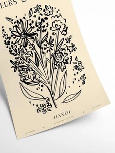 the front cover of an illustrated book with flowers and leaves in black ink on parchment paper