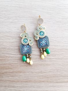 Add a touch of elegance and vibrancy to your wardrobe with these stunning soutache earrings featuring intricate green and yellow tile accents. Handcrafted with care, these earrings are a perfect blend of artistry and style, making them ideal for both casual outings and special occasions. The soutache technique lends a unique texture and dimension to the design, while the striking color combination ensures they will complement a variety of outfits. Whether you're treating yourself or looking for Yellow Tile, Soutache Earrings, Of Outfits, Green And Yellow, Color Combination, Favorite Jewelry, Thoughtful Gifts, Jewelry Earrings Dangle, D Art