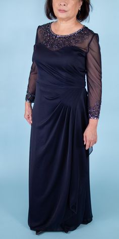 an older woman wearing a black dress with sheer sleeves and beading on the shoulders