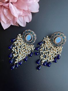 These earrings come in 3 different beautiful colors with a handmade vintage look. It comes in Blue, red, and gray tone and has small beads/pearls as addition to create a statement look. They are gorgeous for a night out and elegant for any outfit as this is a very unique piece and can be paired with many colors. Perfect for gifting and for anyone that loves jewelry, this pair of earrings is sure to leave a mark! Elegant Handmade Kundan Danglers, Elegant Handmade Chandelier Earrings For Festive Occasions, Elegant Beaded Earrings With Dangling Beads For Festive Occasions, Festive Beaded Chandbali Chandelier Earrings, Elegant Festive Beaded Earrings, Handmade Elegant Chandbalis For Festivals, Elegant Handmade Festive Chandbalis, Elegant Pearl Earrings With Dangling Beads For Festivals, Elegant Chandbali Beaded Earrings With Dangling Beads