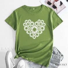 a green t - shirt with white flowers in the shape of a heart on it