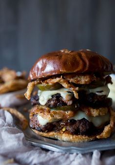 a cheeseburger on a plate with onion rings