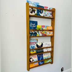 a bookshelf made out of wood with children's books on it