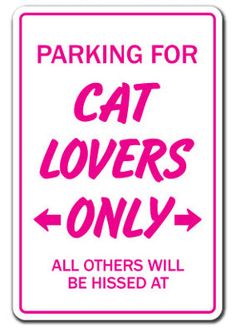 a pink and white sign that says parking for cat lovers only all others will be kissed at