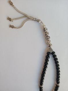 I can make 33 or 99 Tesbih made of black Shiny Original Onyx Stones. You can use it as a personalized gift. It can be an original and beautiful Islamic gift for anniversaries. Names are written on the tassel part. You can also use it as a car accessory if you want. You can hang it on the car mirror and it will look very stylish. With bright beads and custom name it will be meaningful gift to your friends or dad or mom or husband or wife. For Other Products: https://www.etsy.com/shop/TesbihFactor Handmade Black Spiritual Beads, Handmade Spiritual Black Beads, Spiritual Black Beads With Silver Accents, Traditional Black Beads For Gift, Personalized Rosary, Muslim Prayer, Letter Gifts, Metal Letters, Islamic Gifts