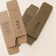 three cardboard boxes with labels on them sitting next to each other in front of a white background