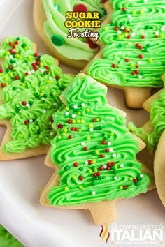 green frosted christmas tree cookies on a white plate