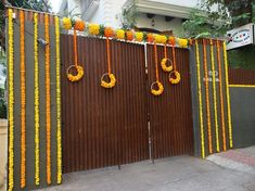 an entrance decorated with orange and yellow garlands