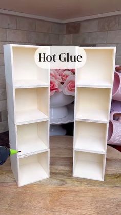 there is a shelf that has two open shelves on it, and the bottom one with pink flowers