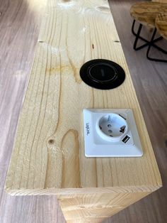 a wooden table with an electrical outlet on it