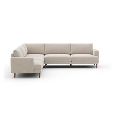 a large sectional couch sitting on top of a white floor next to a wooden frame