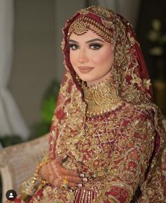 a woman in a red and gold wedding outfit