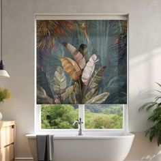 a bathtub sitting next to a window covered in leaves