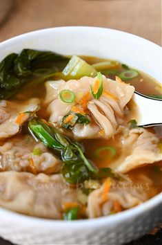 a white bowl filled with soup and vegetables