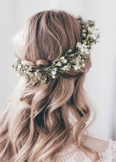 a woman with long hair and flowers in her hair is wearing a floral headpiece