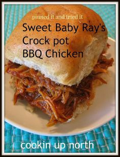 a close up of a sandwich on a plate with text overlay that reads sweet baby rays crock pot bbq chicken