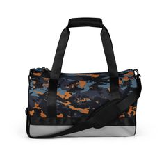 an orange and blue camouflage print duffel bag with black straps on the bottom side