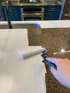 a person cutting paper on top of a counter