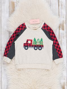 Get your little dude ready for the holidays with this Grey Embroidered Christmas Tree Truck Plaid Shirt. Made with heather grey for comfort and red gingham for style, this top features an embroidered Christmas tree truck on the chest and matching raglan sleeves. Perfect for twinning with little bro! Fits true to size. 97% Cotton / 3% Spandex Combo: 95% Polyester / 5% Spandex Accessories sold separately. Fits true to size. Import. *Afterpay and Sezzle Purchase Requires $35 Minimum Order. Embroidered Christmas Tree, Christmas Tree Truck, Embroidered Christmas, Raglan Shirt, Red Gingham, Raglan Shirts, Plaid Shirt, Raglan Sleeve, Gingham