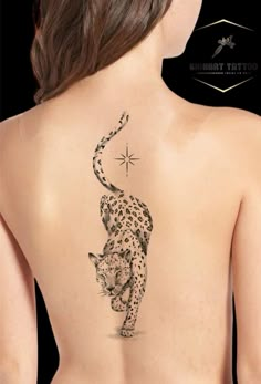 the back of a woman's body with a cheetah tattoo on it